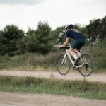 man in black t-shirt riding on bicycle during daytime