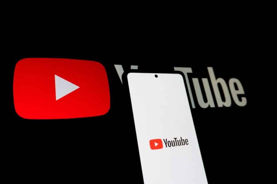 Smartphone displaying youtube logo next to youtube logo